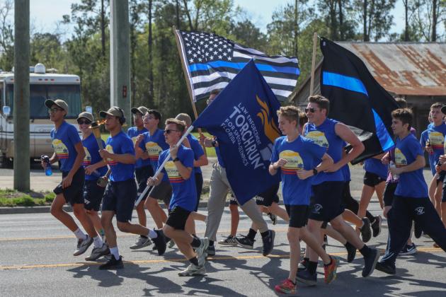 Runners in the Law Enforcement Torch Run finish the final leg of the 1.26-mile run on Friday. Photo by Ashley Chandler/News-Leader