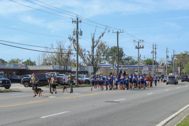 Runners in the Law Enforcement Torch Run finish the final leg of the 1.26-mile run on Friday. Photos by Ashley Chandler/News-Leader