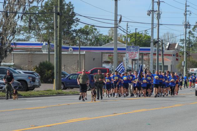 Runners in the Law Enforcement Torch Run finish the final leg of the 1.26-mile run on Friday. Photos by Ashley Chandler/News-Leader