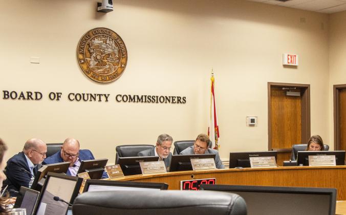 County Commissioners review a resolution Monday that states the board's position against House Bill 1221 at the Board of County Commissioners meeting. From left, commissioners John Martin, Klynt Farmer, A.M. "Hupp" Huppmann, Jeff Gray and Alyson McCullough. If passed, the bill would get rid of the Tourist Development Council, prevent investment into the tourist industry and restrict usage of tourist tax dollars. Photo by Ashley Chandler/News-Leader