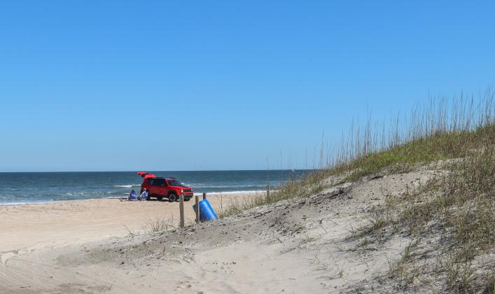 A car parked on the sand at American Beach in March. Photo by Ashley Chandler/News-Leader