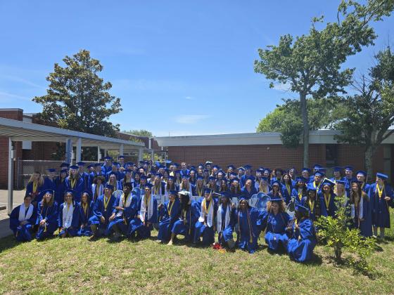 Fernandina Beach High School graduates pose for a group photo Thursday outside Southside Elementary. Photo by Ashley Chandler/News-Leader