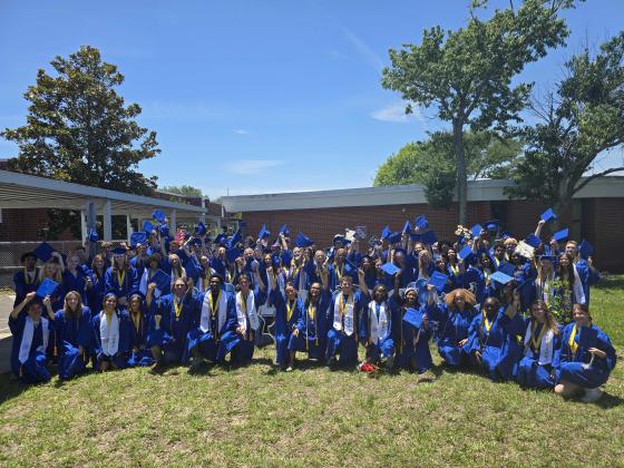 Fernandina Beach High School graduates pose for a group photo Thursday outside Southside Elementary. Photo by Ashley Chandler/News-Leader