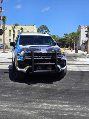 “It’s about time," Fernandina Beach City Commissioner Tim Poynter said as Officer Tina Smith drove a city cruiser over the railroad tracks at the intersection of Alachua and Front streets. The crossing has been closed to vehicular traffic for decades, and was opened in time for the 60th Shrimp Festival. Photo by Julia Roberts/News-Leader