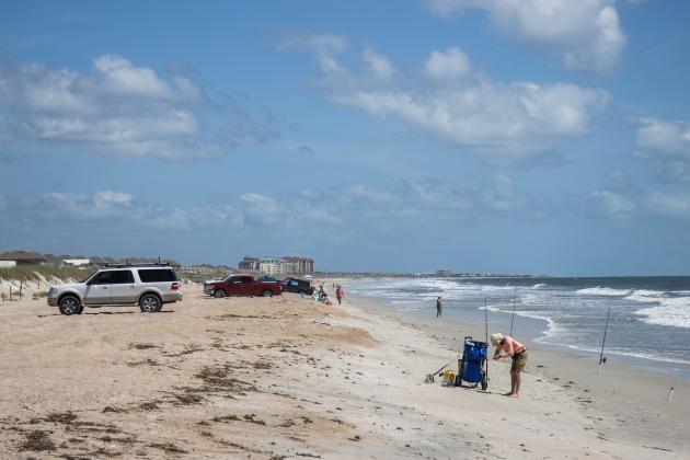 Cars drive and park on the sand at American Beach on Wednesday. Photo by Ashley Chandler/News-Leader