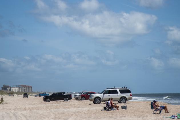 Cars drive and park on the sand at American Beach on Wednesday. Photo by Ashley Chandler/News-Leader
