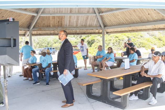 John November, attorney for Save Historic American Beach, Inc., middle, waits to speak at a press conference Wednesday to discuss the lawsuit the nonprofit filed against Nassau County on Tuesday in an attempt to end beach driving at American Beach. Photo by Ashley Chandler/News-Leader