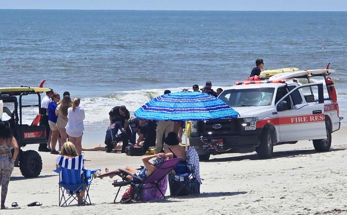 First responders and Ocean Rescue resuscitated a beachgoer who was pulled out of the water Thursday at Main Beach by other visitors. Photo by Ashley Chandler/News-Leader