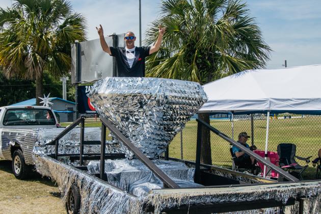 Paul Gaskins, massage therapist at the Ritz-Carlton, poses Thursday afternoon in the Ritz-Carlton's 60th Isle of Eight Flag Shrimp Festival Parade float. Gaskins is the mastermind behind the resort's sparkly diamond float. He constructed it by hand for the parade held Thursday evening. Photo by Ashley Chandler/News-Leader