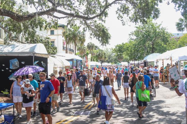 Visitors enjoy the vendors Saturday morning at the 60th anniversary Isle of Eight Flags Shrimp Festival. Photo by Ashley Chandler/News-Leader