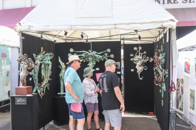 Visitors enjoy the vendors Saturday morning at the 60th anniversary Isle of Eight Flags Shrimp Festival. Photo by Ashley Chandler/News-Leader