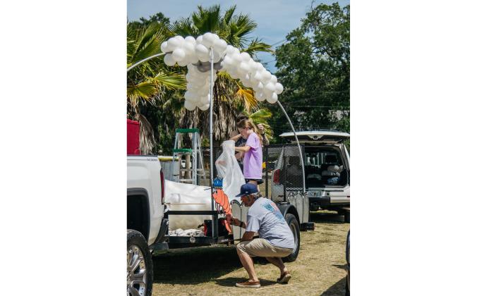 Handmade Happiness 4U setup a float Thursday afternoon for the 60th Isle of Eight Flag Shrimp Festival Parade. Photo by Ashley Chandler/News-Leader
