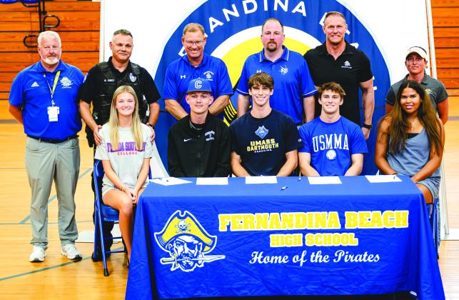 Victoria Rushing, Levi Hutchinson, Jesse Basse, Cael Kubatzke and Callie Brackens, front row from left, signed national letters of intent Wednesday to compete on the college level. Pictured, back row from left, are athletic director Mike Woodard, beach volleyball coach Brian Evatt, baseball coach Jon Shave, basketball coach Matt Bringman, wrestling coach Eric Kubatzke and volleyball coach Paige Subjinski. Photo by Penny Glackin/Special
