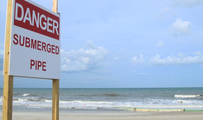 A submerged pipe is shown Wednesday running along a portion of the coastline just north of Main Beach in Fernandina Beach. Photo by Ashley Chandler/News-Leader