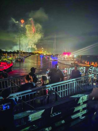 First responders at the scene of the gangway collapse as the fireworks display continues during the Hometown 4th of July Fireworks event at the Fernandina Harbor Marina. Below, the gangway is blocked off Sunday and floats had been added to keep it from falling completely into the water. Ashley Chandler/News-Leader