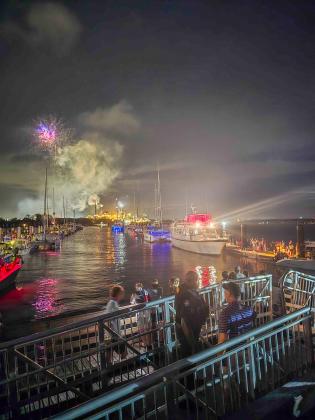 First responders at the scene of the gangway collapse as the fireworks display continues during the Hometown 4th of July Fireworks event at the Fernandina Harbor Marina. Below, the gangway is blocked off Sunday and floats had been added to keep it from falling completely into the water. Ashley Chandler/News-Leader