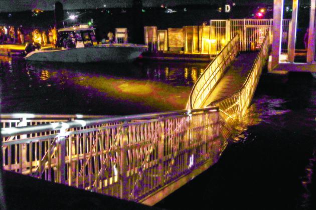 This gangway collapsed Friday night during the Hometown Fourth of July event at the downtown Marina in Fernandina Beach. Attendees of the event watching the fireworks display stood on the gangway that donned a sign that reads ‘BOAT OWNERS ONLY,’ that leads onto the gangway. Photo by Ashley Chandler/News-Leader