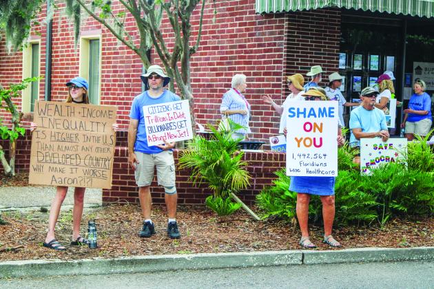 Unified Nassau Florida, a nonpartisan political group in its infancy rooted in progressive values held a protest July 7 outside Congressman Aaron Bean’s local office. Photo by Ashley Chandler/News-Leader