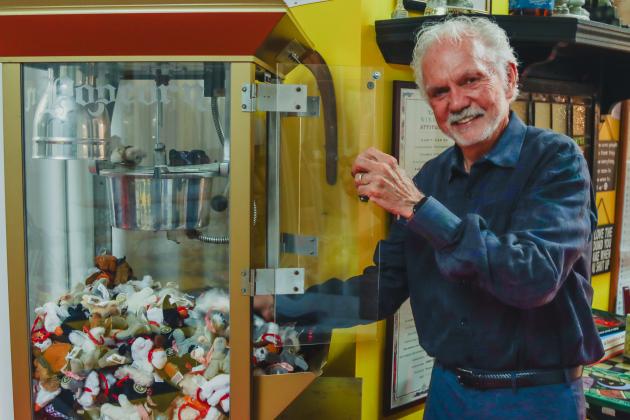 Mike Bowling reaches into his “Pupcorn Machine” which contains old school Mini Pound Puppies. Photo by Ashley Chandler/News-Leader