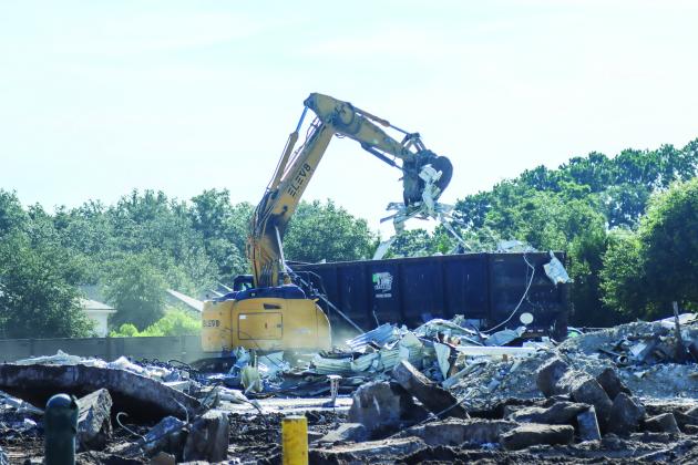 Crews work to clear debris from the demolition of The Island Walk Publix on July 8. Photo by Ashley Chandler/News-Leader