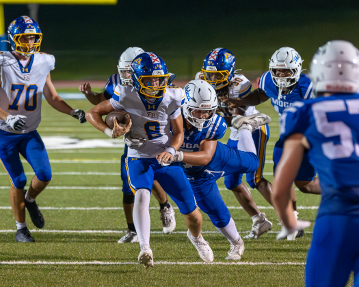 Fernandina Beach High School Football Quarterback Ian Miller carries the ball in Pirates first game of the season at Mount Dora Christian Academy on Aug. 15. Photo by Dana O’Connor/Special to the  News-Leader