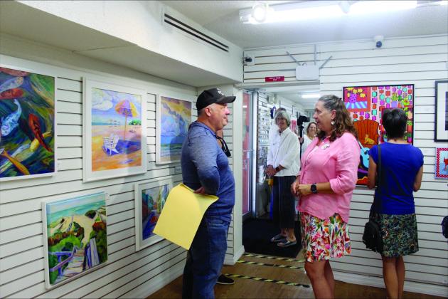 Vice Mayor Darron Ayscue and Alice Henry from the Island Art Association in the gallery on Aug 25. 
