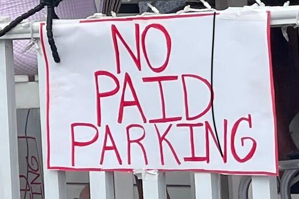 No paid parking sign hung outside local business, Ash Street Cigars