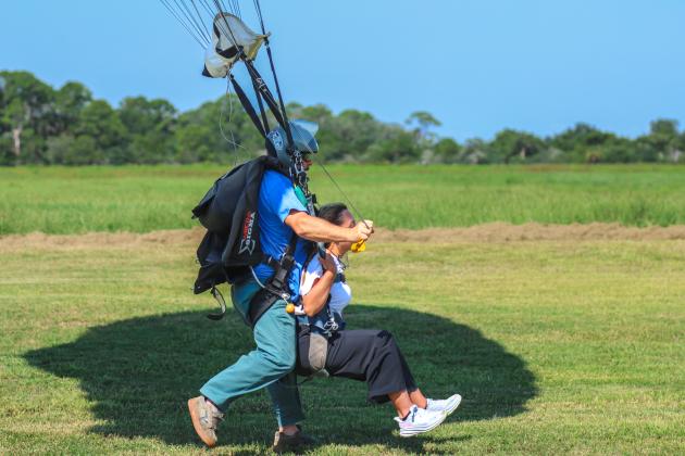 Marisa DeMar and Gregory Meyer land following their jump out of an airplane on Aug. 15.  Photo by Ashley Chandler