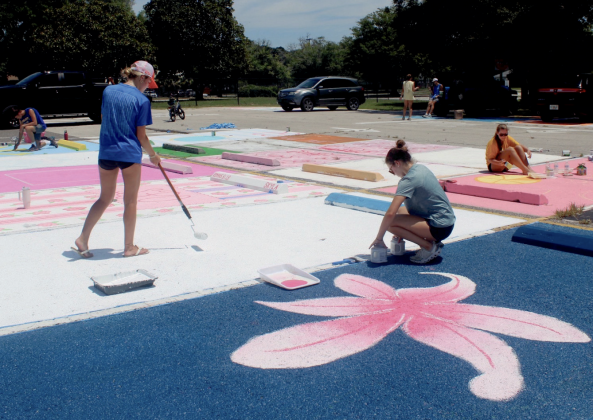 Amelia Oliver and Emma Gunn, FBHS seniors, raise money through painting parking spaces. Photo by Marisa DeMar/New-Leader