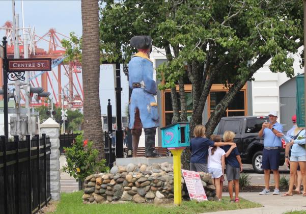 Children pose in front of the statue on Aug. 29 after the discussion of possible cremains took place. Marisa DeMar/News-Leader
