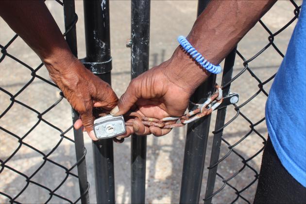 ames and Leatrice Bell hold the lock that blocks access to the George Crady Bridge from the Duval County side on Thursday. By Marisa DeMar/News-Leader 