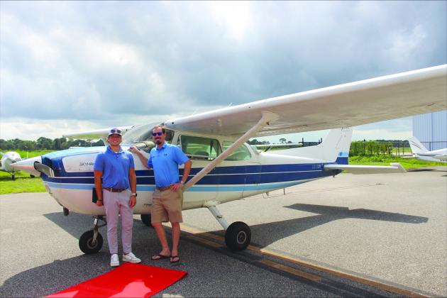 Jack Bishop and Zac Iseminger in front of aircraft at Fernandina Beach Municipal Airport on Aug. 28.
