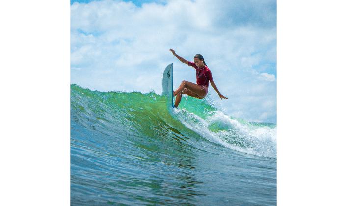 Fernandina Beach’s Mikaela Nichols rides a wave at a Main Beach competition, Aug. 24.  Photo by Southern Edge Studios
