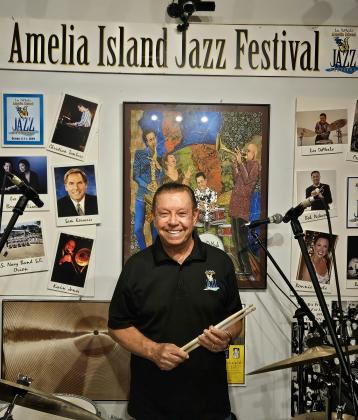 Jim Luksic/News-Leader  Amelia Island Jazz Festival co-founder and drummer Les DeMerle stands at a drum kit in his Fernandina Beach garage.