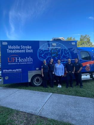UF Health employees (from left) Sarah Harrell, Libby Harrington, Lindsey Perrotta, Captain Hutchens, and Lieutenant Williams pose outside of the mobile stroke unit at the Council on Aging. Marisa DeMar/News-Leader