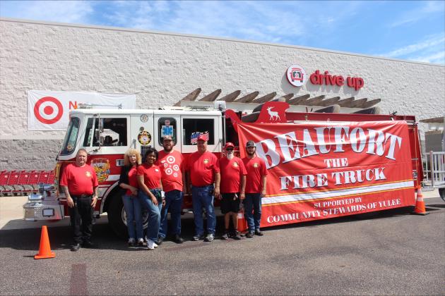 Volunteers pose with “Beaufort” the firetruck to gain support for Water For First Responders.