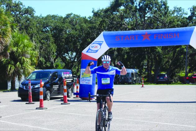 Rider John Riordan crosses the finish line at the Watermelon Ride on Sunday. Photos by Marisa DeMar/News-Leader