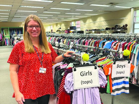 McKinney-Vento Program Manager Mollie Cressey stands at the front of the clothes closet, which is run by volunteers.