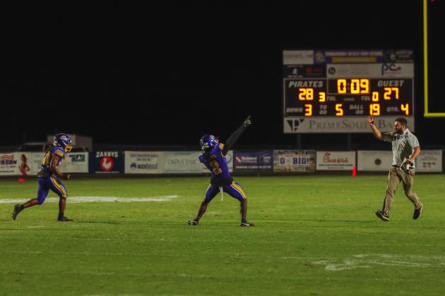 Fernandina Beach’s Traivon Martin, left, and Aydin Poe run to the bench to celebrate with coaches and teammates as the clock runs out Friday night in a 1-point win over the Fort White Indians.. Photo by Ashley Chandler/News-Leader