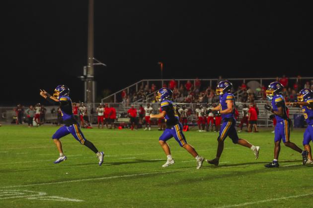 Fernandina Beach special teams unit players run to the sideline in celebration following the Indians’ missed extra point attempt in the fourth quarter. The Pirates ran out the clock to win 28-27. Photo by Ashley Chandler/News-Leader