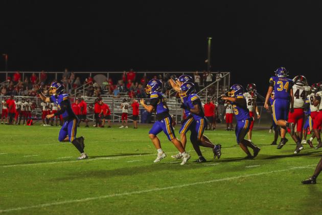 Fernandina Beach special teams unit players run to the sideline in celebration following the Indians’ missed extra point attempt in the fourth quarter. The Pirates ran out the clock to win 28-27. Photo by Ashley Chandler/News-Leader