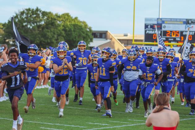 Fernandina Beach cheerleaders and future Pirate athletes led the Pirates onto the field Friday for their game against the Indians. Photo by Ashley Chandler/News-Leader