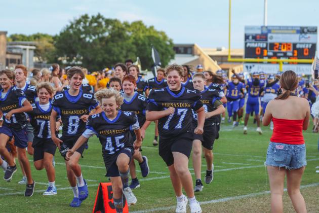 Fernandina Beach cheerleaders and future Pirate athletes led the Pirates onto the field Friday for their game against the Indians. Photo by Ashley Chandler/News-Leader