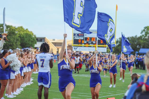 Fernandina Beach cheerleaders and future Pirate athletes led the Pirates onto the field Friday for their game against the Indians. Photo by Ashley Chandler/News-Leader