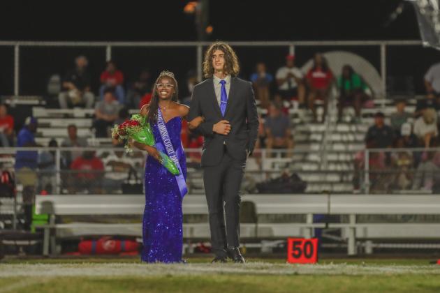 Fernandina Beach High School Homecoming Queen Passion Roberts is escorted by her boyfriend, Leyton Mezzio-Velardi, during FBHS football halftime on Friday.