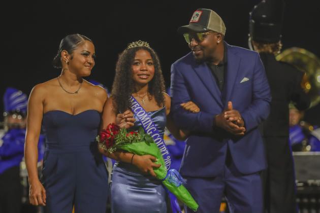 Homecoming Princess Serenity Bell is escorted by her father Sylvester Bell, right, and her mother Rita Bell. Photo by Ashley Chandler/News-Leader