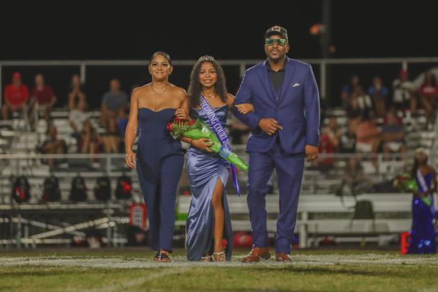 Homecoming Princess Serenity Bell is escorted by her father Sylvester Bell, right, and her mother Rita Bell. Photo by Ashley Chandler/News-Leader
