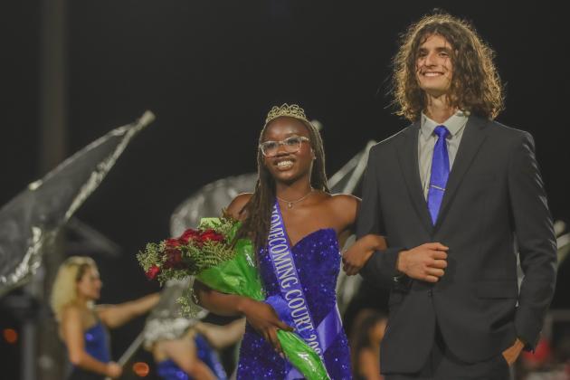 Fernandina Beach High School Homecoming Queen Passion Roberts is escorted by her boyfriend, Leyton Mezzio-Velardi, during FBHS football halftime on Friday.