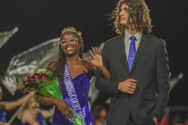 Leyton Mezzio-Velardi escorts Passion Roberts, left, during the Fernandina Beach High School football halftime recognition of the homecoming court Friday. Roberts was crowned FBHS homecoming queen. Photo by Ashley Chandler/News-Leader