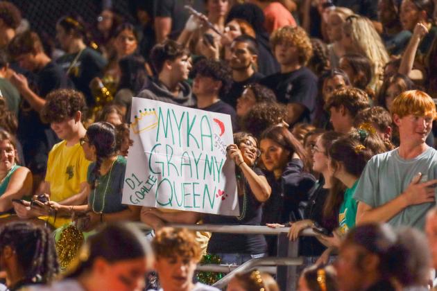 Some students brought signs to Friday night’s game cheering on their favorite homecoming court candidate. Photo by Ashley Chandler/News-Leader